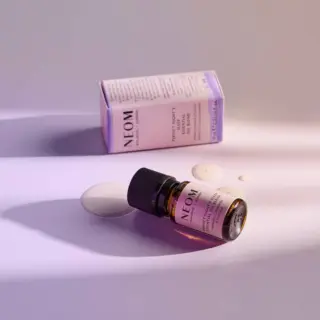 NEOM Perfect Night's Sleep oil bottle and box on a light purple surface.