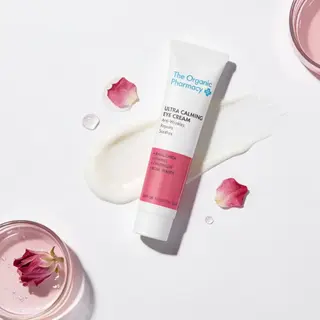 The Organic Pharmacy Ultra Calming Eye Cream with rose petals and cream smear.
