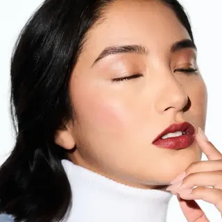 Woman with closed eyes, wearing red lipstick and white turtleneck. Text: "CRYSTAL SLIPPER".
