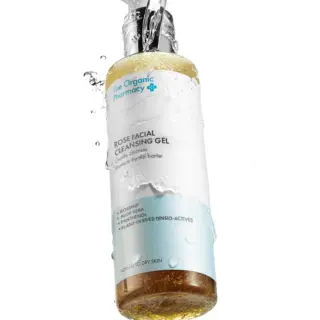 The Organic Pharmacy Rose Facial Cleansing Gel with water splashes.