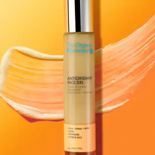 Antioxidant Face Gel by The Organic Pharmacy on orange background with gel smear.