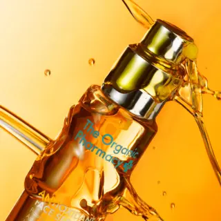 The Organic Pharmacy Antioxidant Face Serum with liquid splash.
