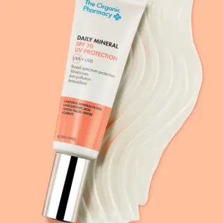 Tube of Daily Mineral SPF 30 on a peach background with cream swatch.