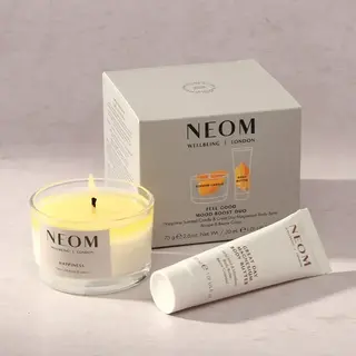 NEOM Feel Good Mood Boost Duo with candle and body butter on a light surface.