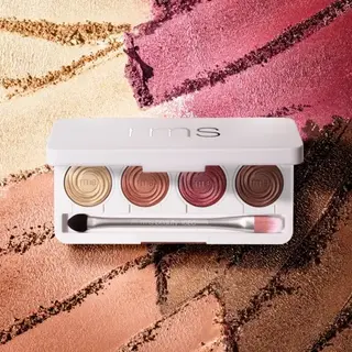 Eyeshadow palette with five shades and brush on textured background.
