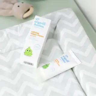 Organic Babies calming nappy cream on a patterned changing mat.