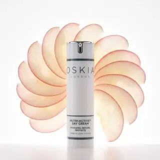 Oskia London Nutri-Active Day Cream with apple slices in the background.
