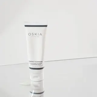Oskia London Perfect Cleanser tube on reflective surface.