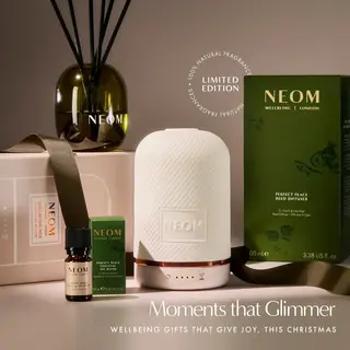 NEOM diffuser set with reed diffuser, oil blend, and packaging. Text: "Moments that Glimmer".