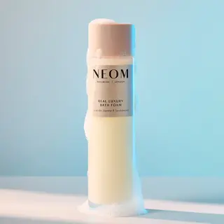 NEOM Real Luxury Bath Foam bottle with bubbles, lavender, jasmine, sandalwood scent.