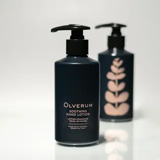 Two bottles of Olverum Soothing Hand Lotion with pump dispensers.