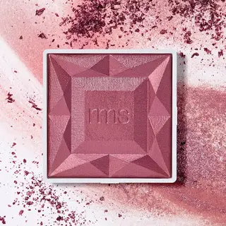 Pink geometric blush compact with "rms" embossed, surrounded by scattered blush powder.