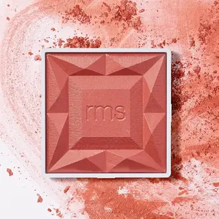 RMS Beauty blush compact on a textured pink powder background.