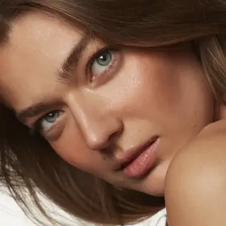 Close-up of a woman's face with natural makeup. Text: "MALIBU MUSE" in the corner.