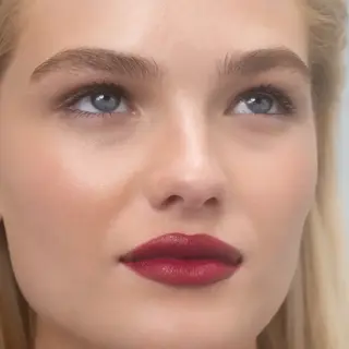 Woman with red lipstick and blue eyes, text "MONICA" in the corner.