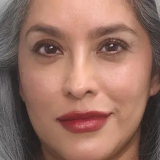 Woman with grey hair and red lipstick, text "Mickey" in corner.
