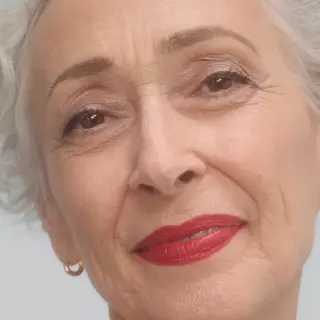 Older woman with short grey hair and red lipstick. Text: "RUBY MOON".