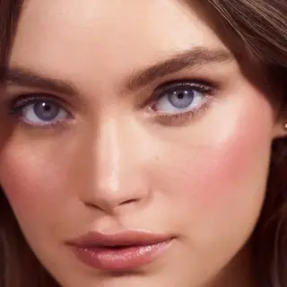 Close-up of a woman's face with pink blush. Text: "MAIDENS BLUSH" in the corner.