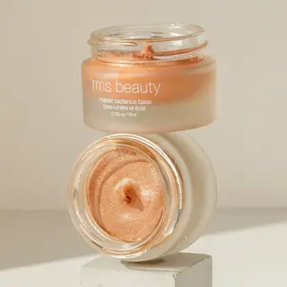 RMS Beauty Master Radiance Base in open jar on a white block.