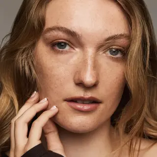 Person with freckles and light brown hair, touching face. Text: "CAMEO" in the corner.