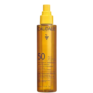 Caudalie SPF 50 glow oil spray bottle, 150ml, yellow with blue text.