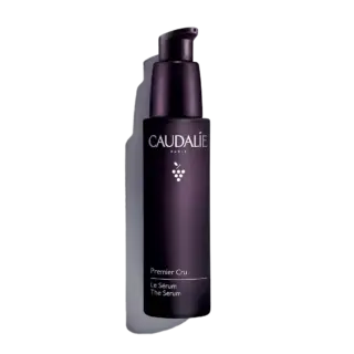 Dark purple bottle of Caudalie Premier Cru Le Sérum with pump dispenser.