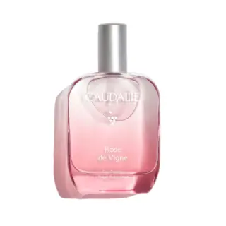 Caudalie Rose de Vigne Eau Fraîche fragrance in a pink glass bottle with a silver cap.