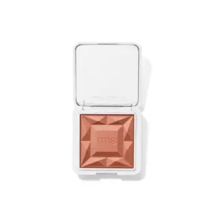 Open compact with embossed peach powder and "rms" text. White case with "rms beauty" on lid.