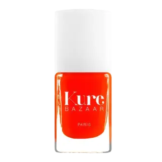 Kure Bazaar Paris nail polish in bright orange with a white cap.
