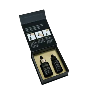 Open box with two black skincare bottles and usage instructions on the lid.