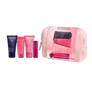Skincare set with four Caudalie products and a pink pouch.