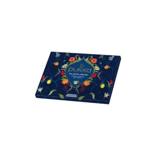 Pukka tea advent calendar box with floral and fruit design on a dark background.
