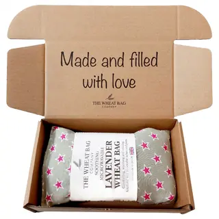 Open box with lavender wheat bag, pink stars, text: "Made and filled with love".