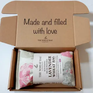 Lavender wheat bag in a box with "Made and filled with love" text on the lid.