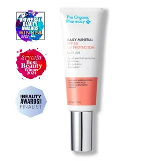 The Organic Pharmacy Daily Mineral SPF 30 tube with award badges.