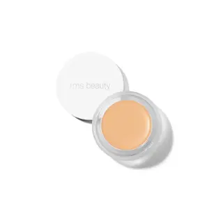 Open jar of rms beauty concealer with white lid.