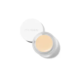 Open jar of beige cream with "rms beauty" on the lid, viewed from above.