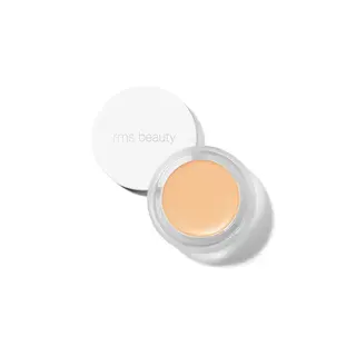 Open jar of rms beauty concealer with lid beside it.