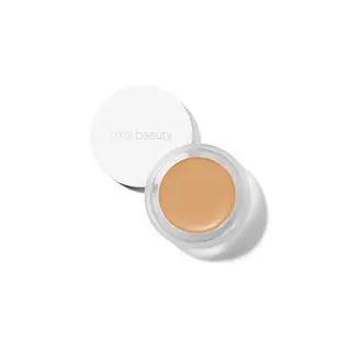 Open jar of rms beauty concealer with lid beside it.