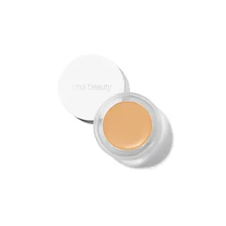 Open jar of beige cream with "rms beauty" on the lid.