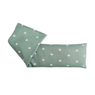 Green polka dot fabric eye pillow, folded at one end.
