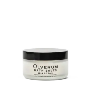 Olverum Bath Salts jar with black lid, labelled with essential oils.