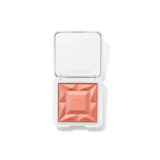 Open compact with peach blush, embossed "rms", in white case.