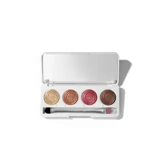 Open eyeshadow palette with four shades and a brush.