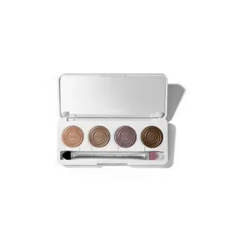 Open eyeshadow palette with four shades and a brush.