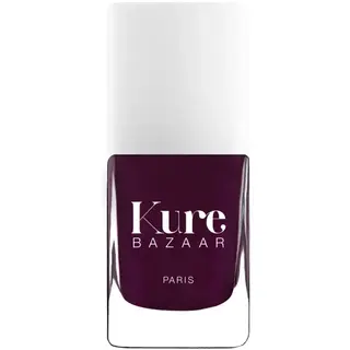 Kure Bazaar nail polish bottle, dark purple shade, white cap.