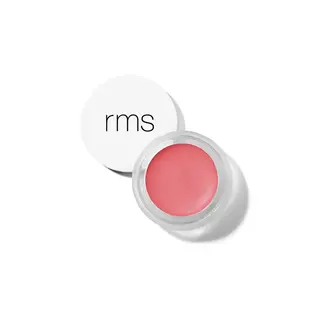 Open jar of pink lip balm with "rms" on the white lid.