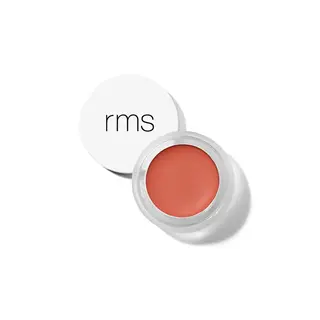 Open pot of coral lip balm with white lid displaying "rms" text.