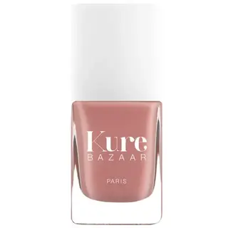 Kure Bazaar nail polish bottle with white cap, pink shade, text "Kure Bazaar Paris".