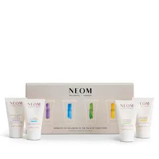 NEOM hand balm set with four tubes and branded packaging.